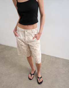 Model wearing Denim barrel jort in ecru jacquard floral