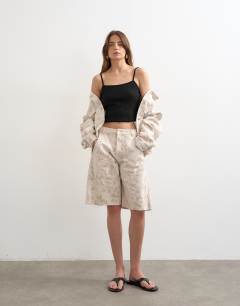 Model wearing Denim barrel jort in ecru jacquard floral