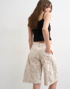 Model wearing Denim barrel jort in ecru jacquard floral
