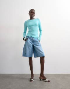 Model wearing Denim barrel jort in mid blue