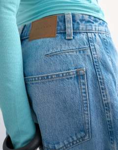 Model wearing Denim barrel jort in mid blue