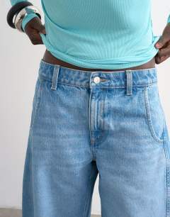 Model wearing Denim barrel jort in mid blue