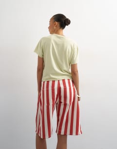 Model wearing Denim barrel jort in red stripe