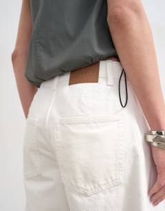 Model wearing Denim barrel jort in white