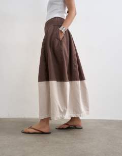Model wearing Denim barrel seamed maxi skirt in brown and ecru