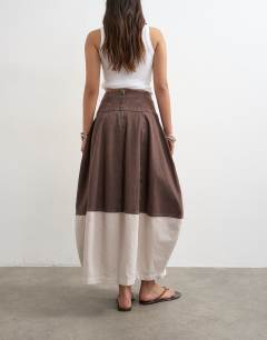 Model wearing Denim barrel seamed maxi skirt in brown and ecru