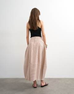 Model wearing Denim barrel seamed maxi skirt in red and ecru stripe