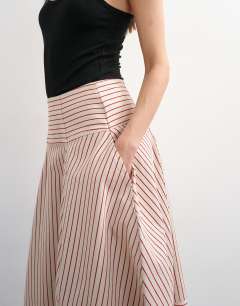 Model wearing Denim barrel seamed maxi skirt in red and ecru stripe