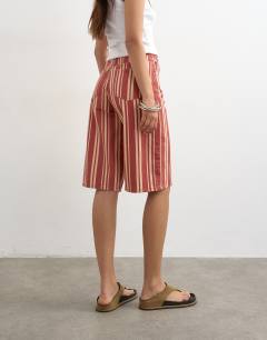 Model wearing Denim bermuda short in red stripe