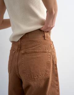 Model wearing Denim bermuda short in toffee