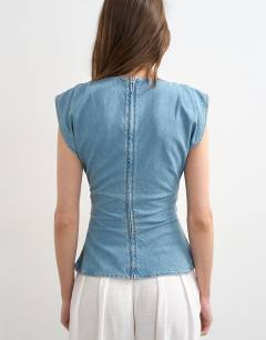 Model wearing Denim boat neck ruched side top in mid blue