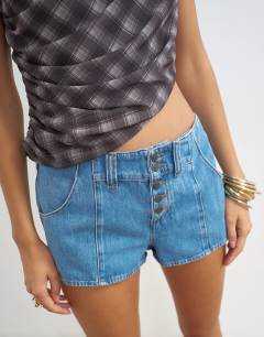 Model wearing Denim button fly knicker short in mid blue