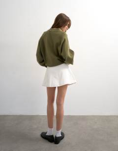 Model wearing Denim button through mini skirt in ecru