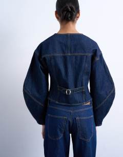 Model wearing Denim cinch back shirt with ovoid sleeve in rinse