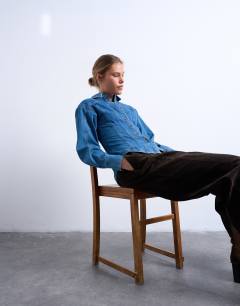 Model wearing Denim cinched shirt with seam detail in mid blue
