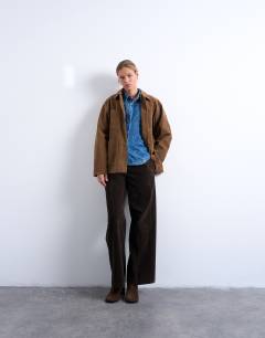 Model wearing Denim cinched shirt with seam detail in mid blue