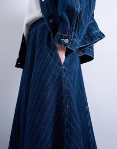 Model wearing Denim circle maxi skirt in indigo stripe