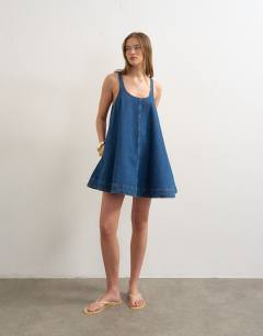 Model wearing Denim circle pinny dress in rich blue
