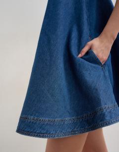 Model wearing Denim circle pinny dress in rich blue