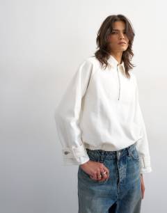 Model wearing Denim collared quarter zip blouson jacket in bone