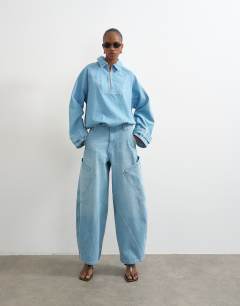 Model wearing Denim collared quarter zip blouson jacket in mid blue