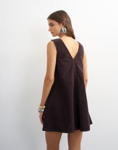 Model wearing Denim cord pinny v neck mini dress in chocolate