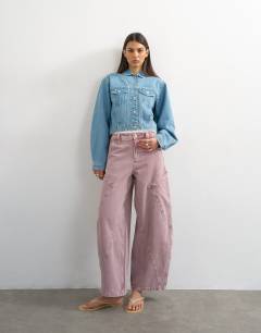 Model wearing Denim cropped padded shoulder jacket in bleach