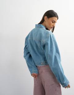 Model wearing Denim cropped padded shoulder jacket in bleach