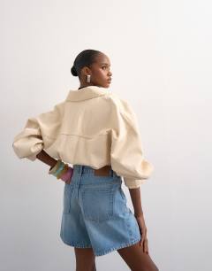 Model wearing Denim Editor short in bleach