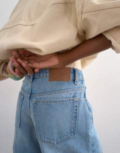 Model wearing Denim Editor short in bleach