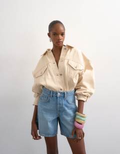 Model wearing Denim Editor short in bleach