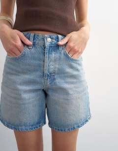 Model wearing Denim Editor short in bleach