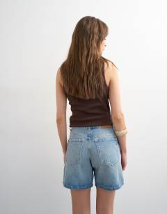 Model wearing Denim Editor short in bleach