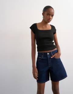 Model wearing Denim Editor short in indigo rinse