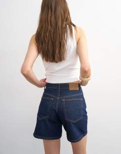 Model wearing Denim Editor short in indigo rinse