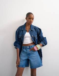 Model wearing Denim Editor short in mid blue