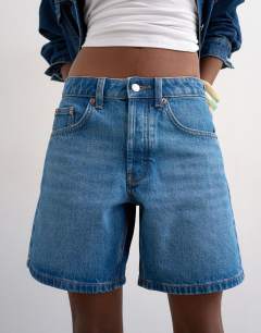 Model wearing Denim Editor short in mid blue