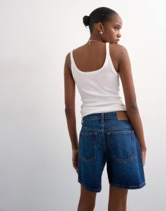 Model wearing Denim Editor short in rich blue