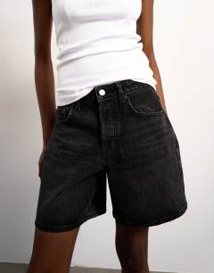 Model wearing Denim Editor short in washed black