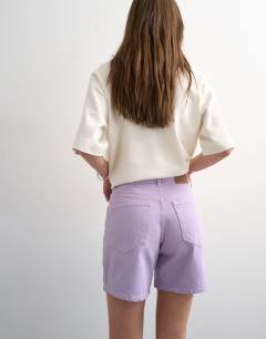 Model wearing Denim Editor shorts in lilac