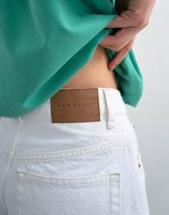 Model wearing Denim Editor shorts in white