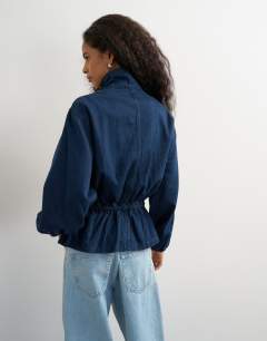 Model wearing Denim elasticated waist funnel sporty track jacket in indigo