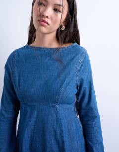 Model wearing Denim flute sleeve mini dress in mid blue