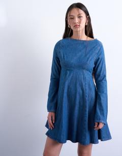 Model wearing Denim flute sleeve mini dress in mid blue