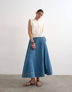 Model wearing Denim full maxi skirt in mid blue