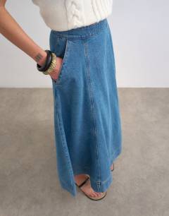 Model wearing Denim full maxi skirt in mid blue