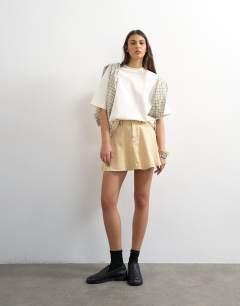 Model wearing Denim full mini skirt in buttermilk