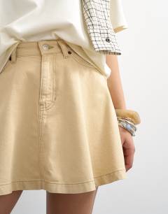 Model wearing Denim full mini skirt in buttermilk
