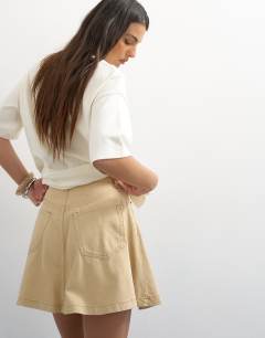 Model wearing Denim full mini skirt in buttermilk