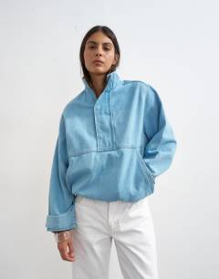 Model wearing Denim funnel neck bubble hem top in bleach